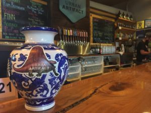 A tip jar vase on the counter at Urban Artifact